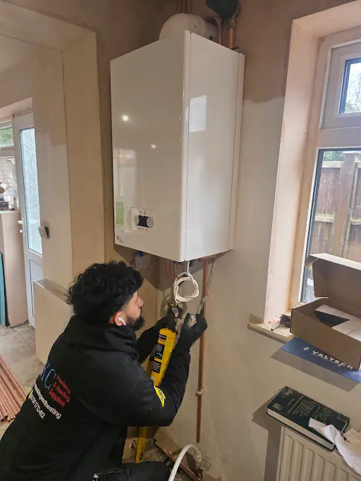 KC Plumbing engineer installing a boiler