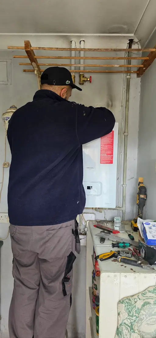 Engineer working on boiler pipework